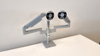 Humanscale dual monitor arm in silver, mounted on desk